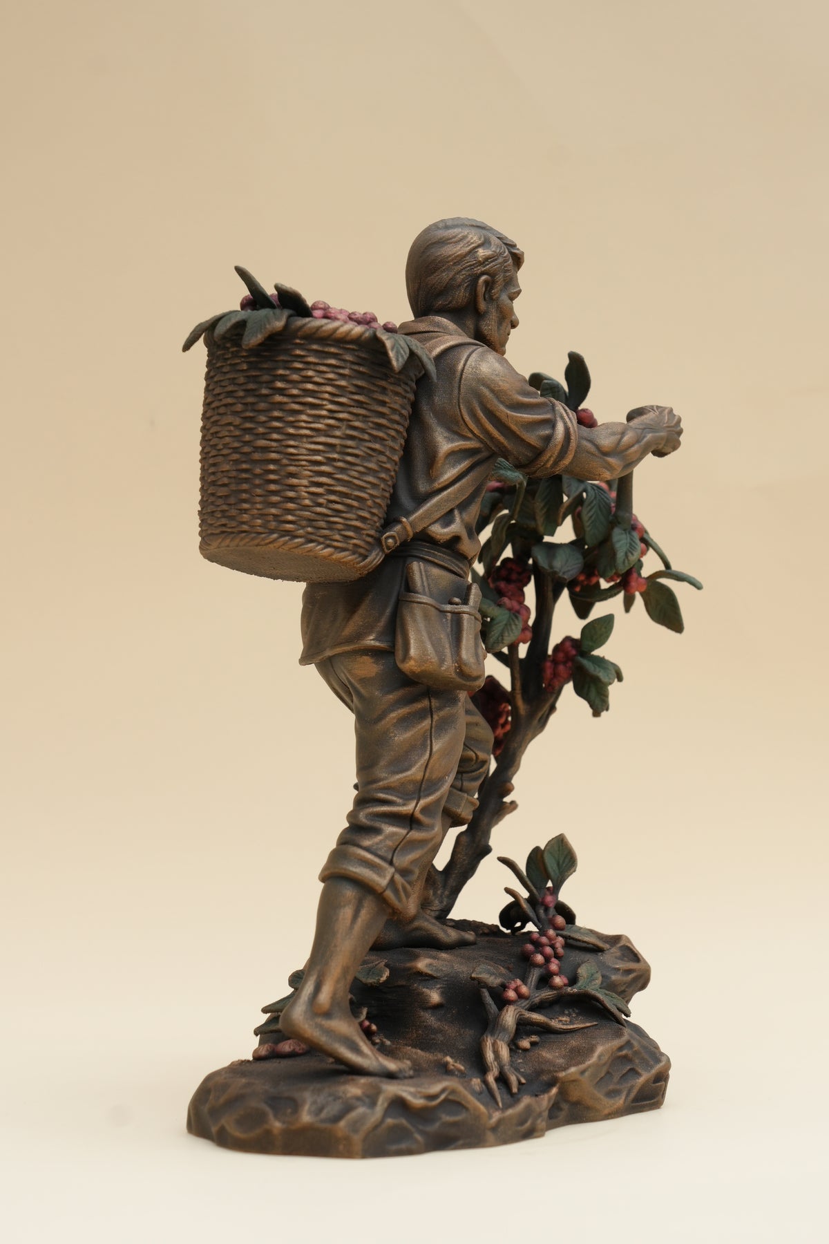 Coffee Harvester sculpture, coffee branches and painted berry detail
